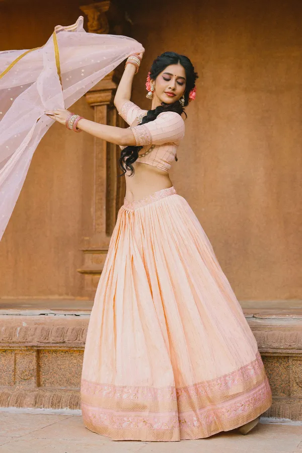 Traditional Craftsmanship: Nabha Natesh in Peach & Gold Lehenga