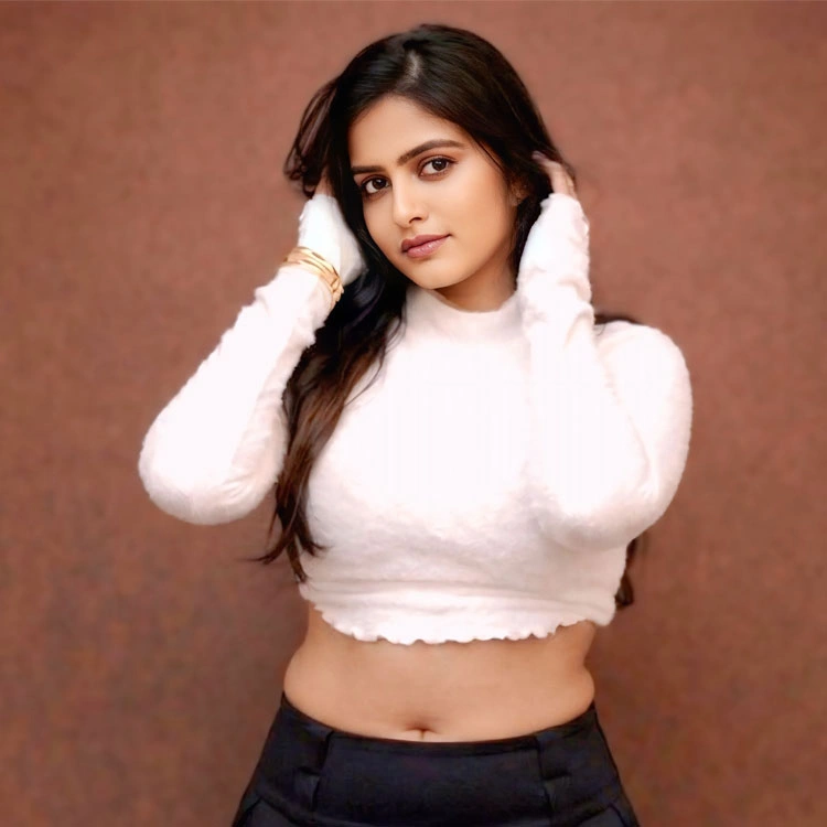 Pragya Nayan Turns Up the Heat in a White Fuzzy Crop Turtleneck and Black Pleated Mini Skirt